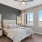 Master bedroom with large windows and wood-style flooring