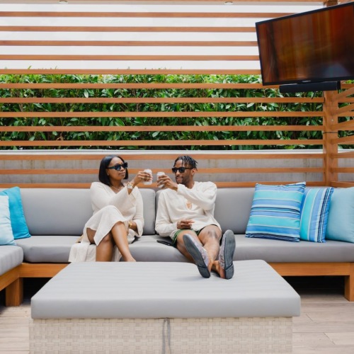 a couple reclines in outdoor lounge a couple reclines in outdoor lounge