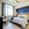 A large bedroom with oversized windows and chair