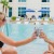 two women have drinks in a pool