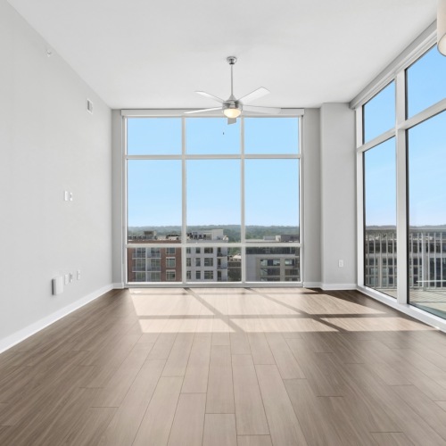 large room with large windows and wood floors